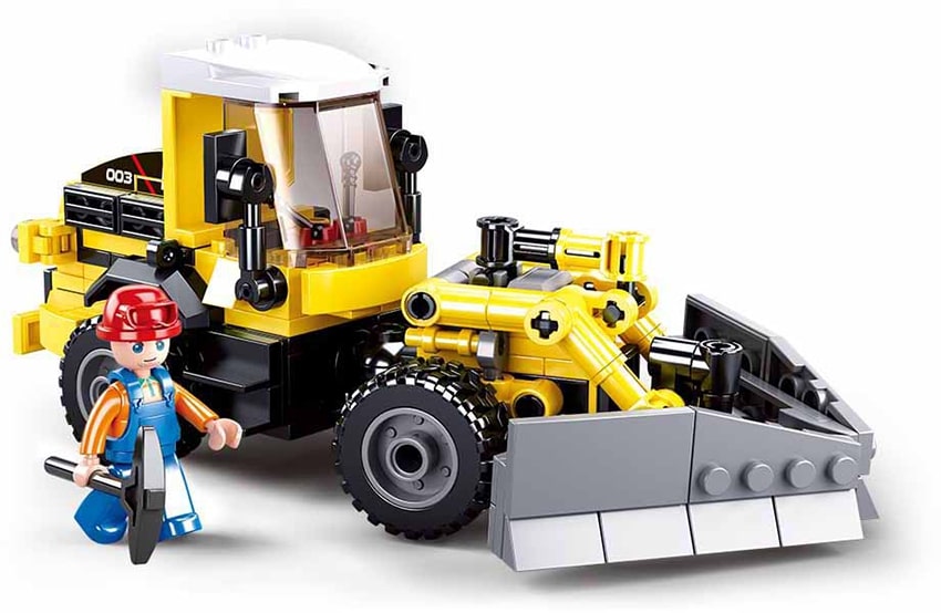 Toy bulldozer with a small figure on a white background