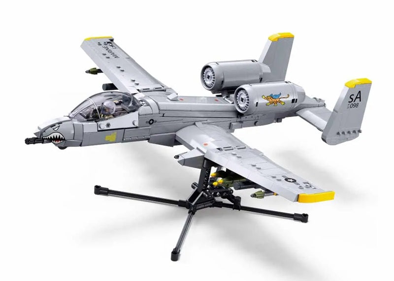 Model airplane on a stand with a white background