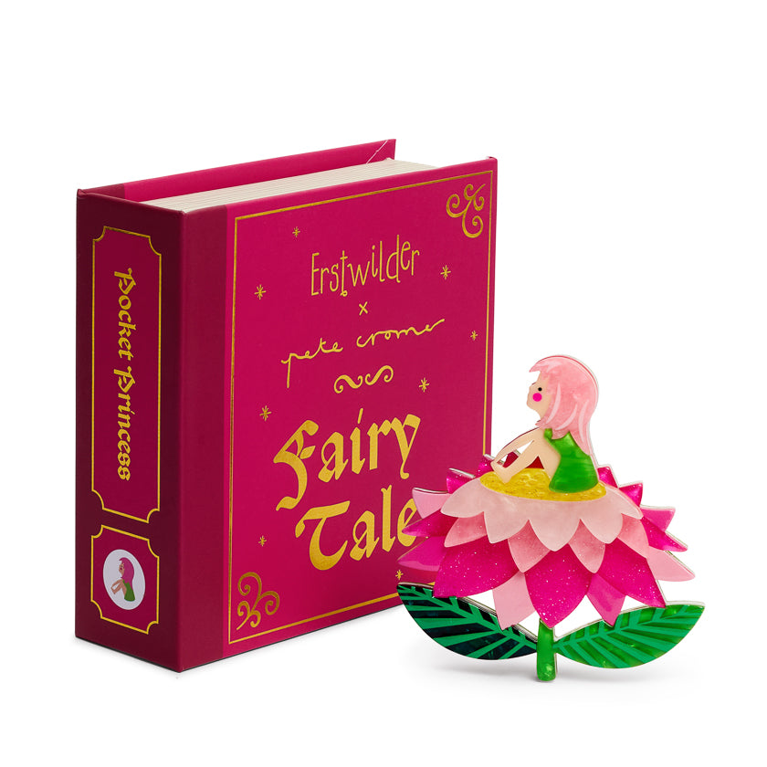 Pink fairy tale book with a minute girl sitting on a pink flower on a white background