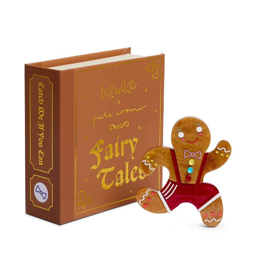 Book titled 'Fairy Tales' with a gingerbread man brooc on a white background