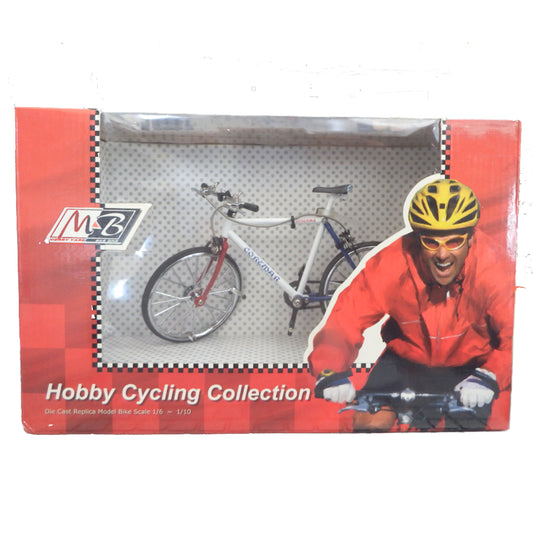 Model bicycle in packaging with cyclist illustration and MZ logo