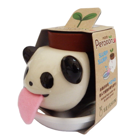 Cute panda-shaped container with a pink tongue伸出, standing on a white surface with a brown packaging box.