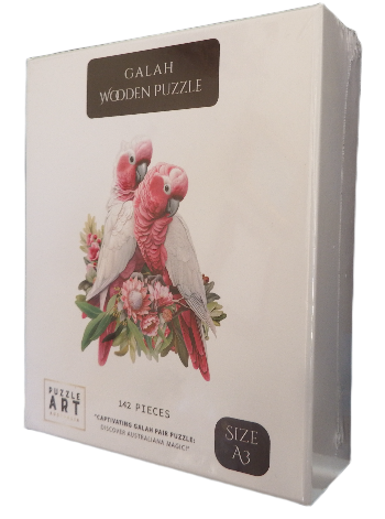 Wooden puzzle packaging with two pink cockatoos and floral design on a white background