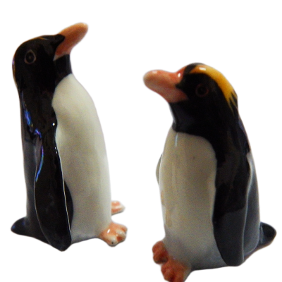 Two glass penguin figurines on a white background