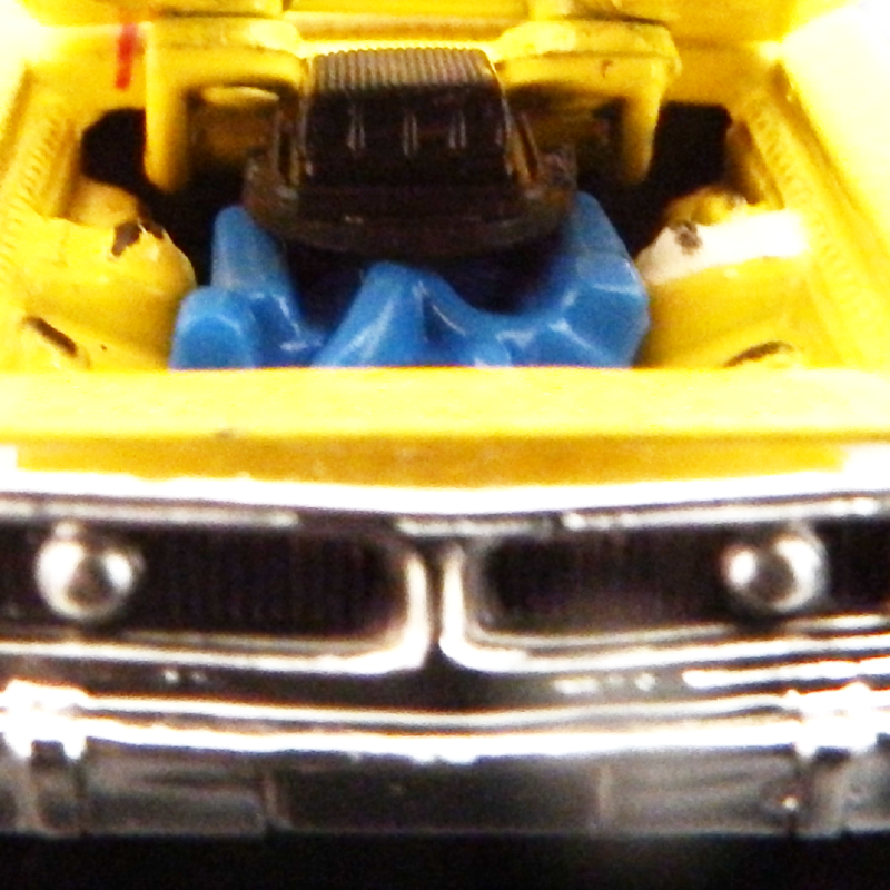 Close-up of a toy car with open hood showing engine details