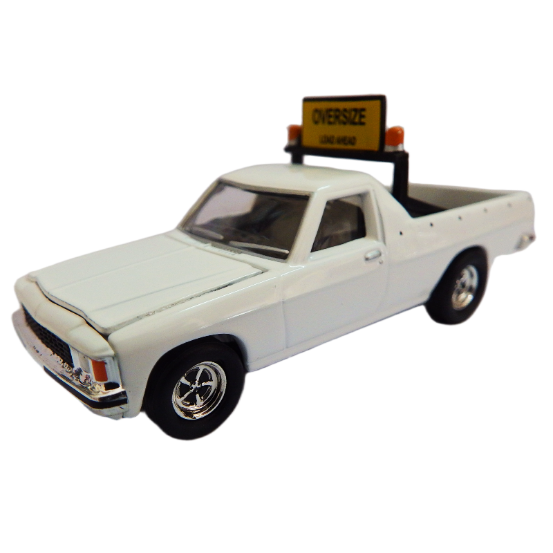 Model pilot  Ute 1982 WB with yellow sign sign reading Oversize load ahead on top against a white background