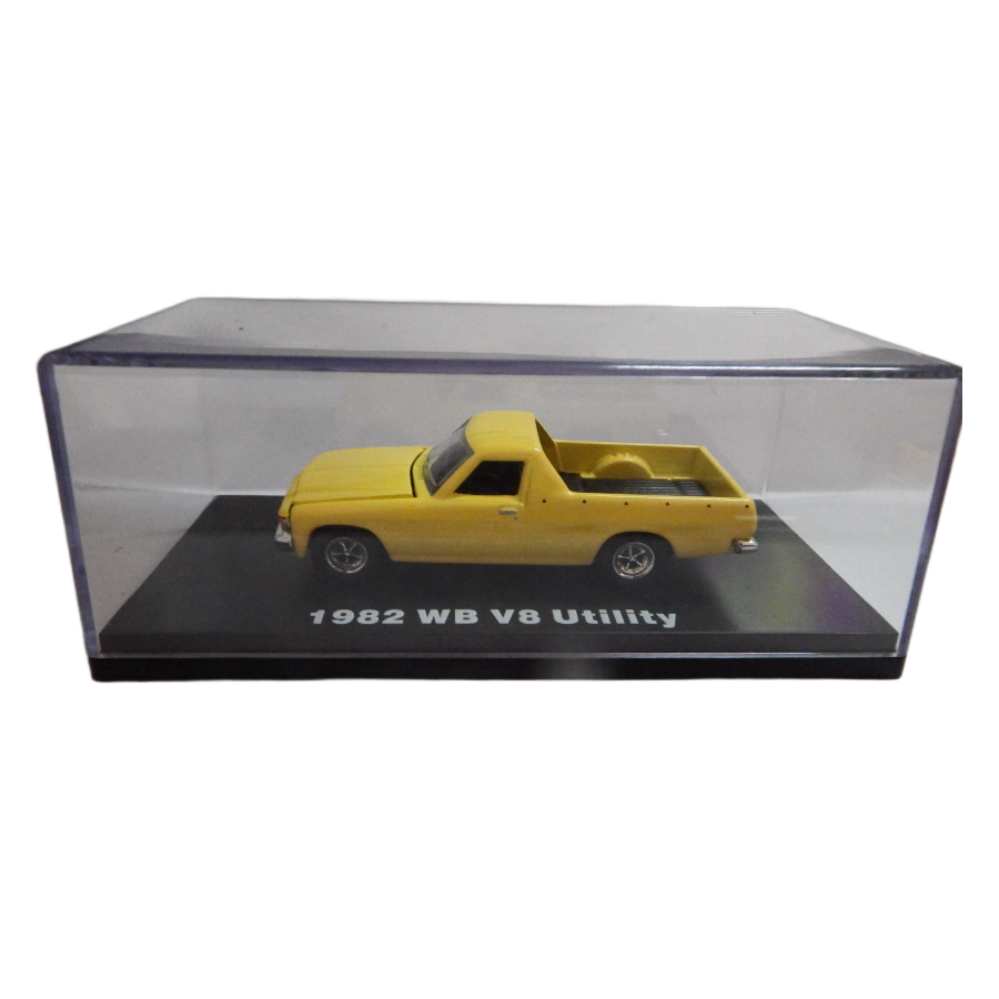 Yellow model truck in a clear display case on a white background
