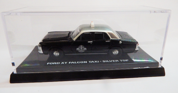 Model of a Ford XY Falcon Taxi with a silver top on a display stand.