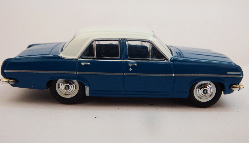 Model of a blue car with white top on a light gray background