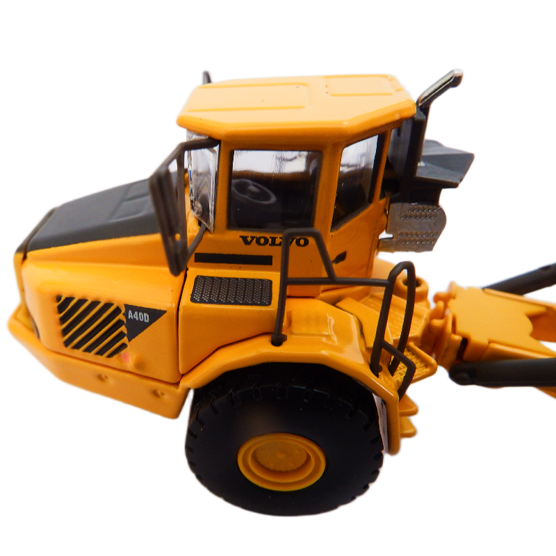 Toy construction vehicle with Volvo branding on a white background