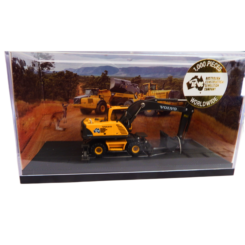 Model of a Volvo excavator in a clear display case with a scenic background
