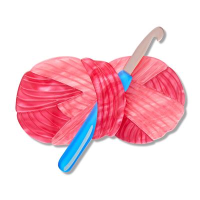 Pink yarn ball with a blue & grey crochet hook on a white background