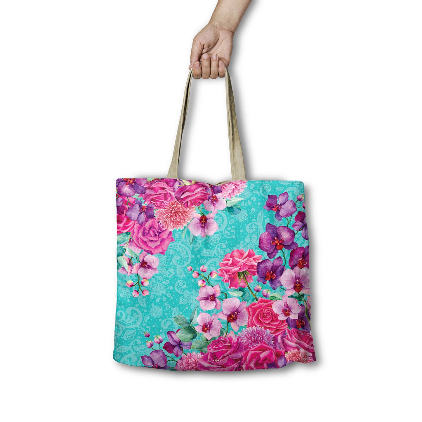 Floral tote bag held by a hand on a white background
