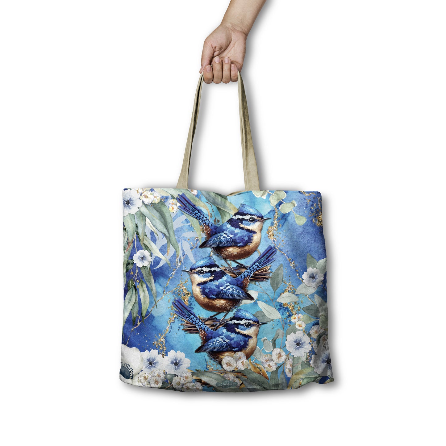 Tote bag with blue bird design held by a hand on a white background