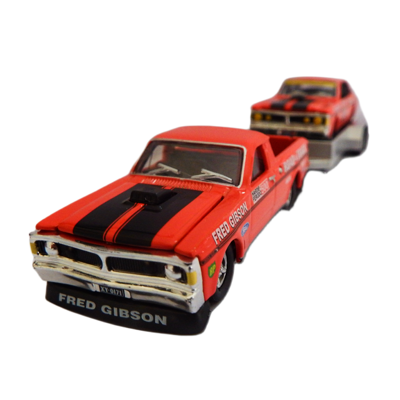 Red toy truck with black stripes and 'Fred Gibson' branding on a white background