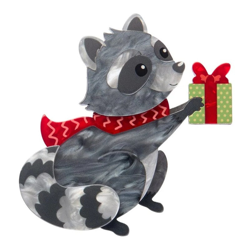 Illustration of Erstwilder brooch raccoon wearing a red scarf with a gift box in the backgrounder