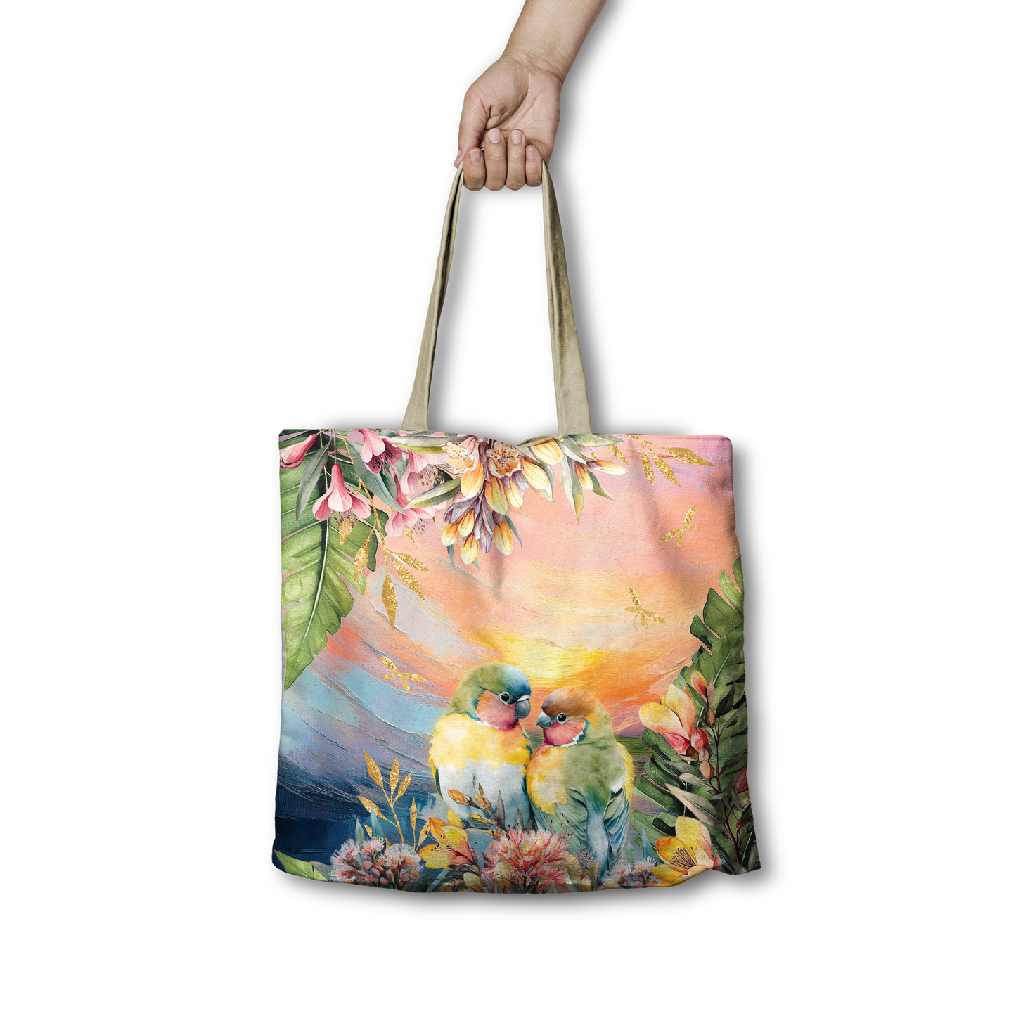 Tote bag with a colorful design of love bird parrots and foliage held by a hand on a white background