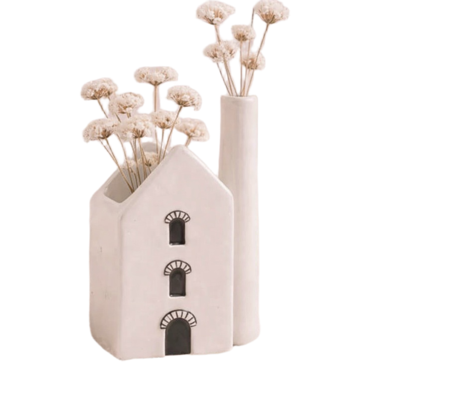 Ceramic Cornish Pumphouse house-shaped vase with dried flowers on a white background