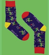 Colorful socks with cartoon crocodile characters playing cricket on a green background.
