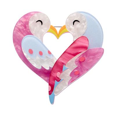 Heart-shaped pink bird design with cartoon faces on a white background
