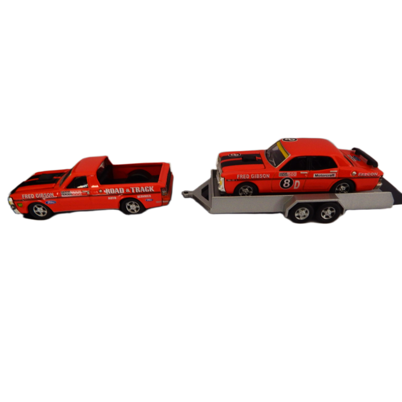 Model of a red tow truck with a car on a white background