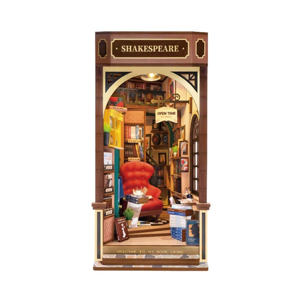 Model of a bookshop with a red chair and 'Shakespeare' sign on a white background