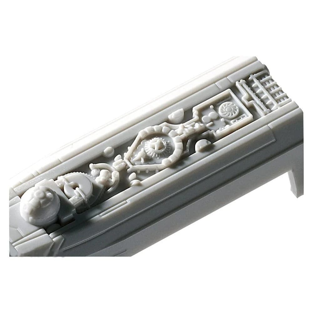 A close-up of a light gray plastic miniature accessory with detailed sculpted patterns, shown on a plain white background.