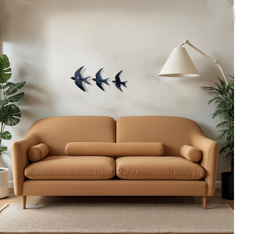 Beige sofa in a living room with plants and set of 3 wall swallow porcelain wall art