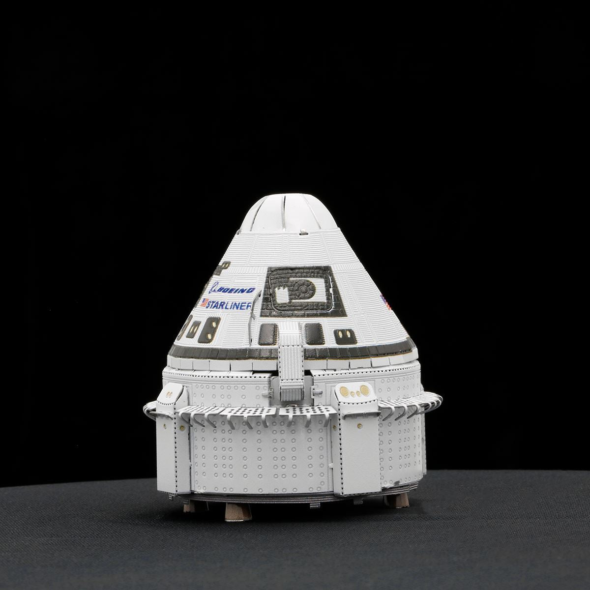 Model of a spacecraft with 'Boeing' and 'Starliner' branding on a black background