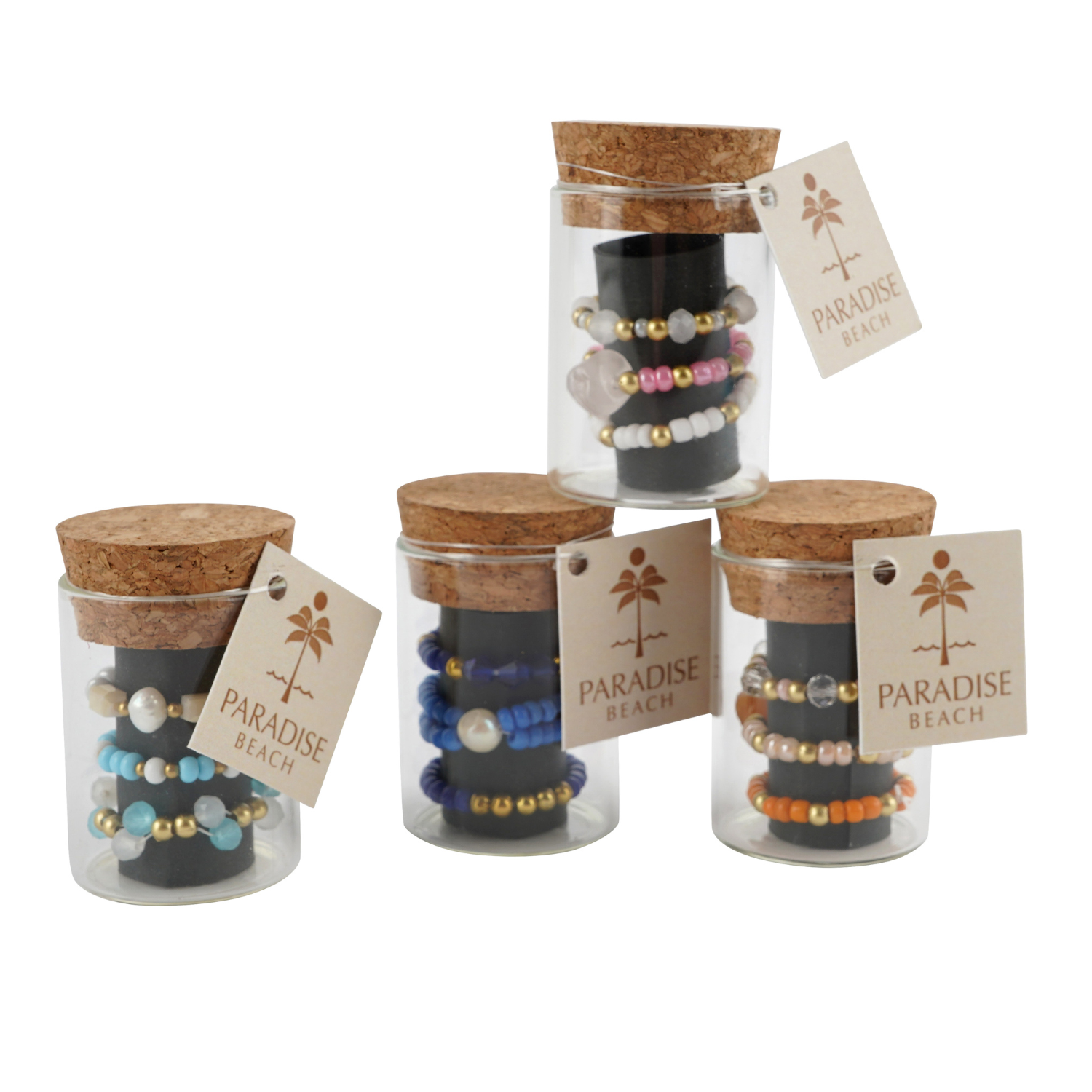 Set of glass jars with cork lids containing beaded rings, each labeled 'Paradise Beach'.