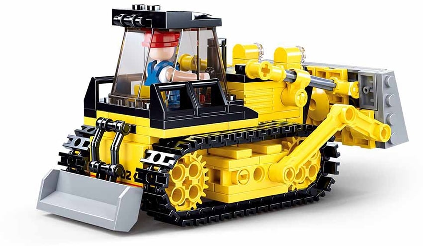 Toy bulldozer made of interlocking bricks on a white background