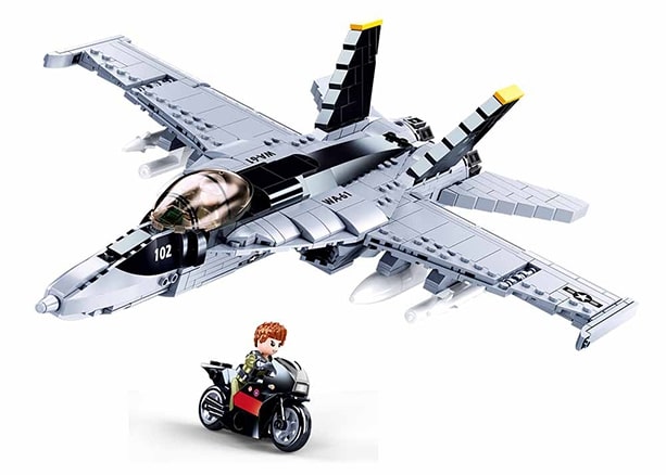 Toy model of a fighter jet with a smaller figure on a white background