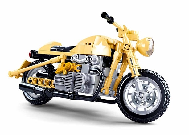 Yellow motorcycle model made of interlocking bricks on a white background