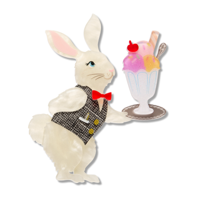 Decorative rabbit Erstwilder brooch holding an ice cream sundae on a white background