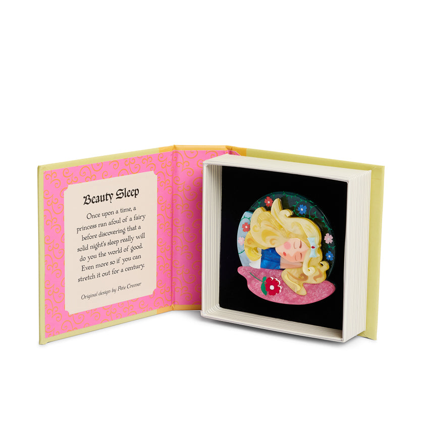 Open book with a sleeping beauty illustration and text on a white background