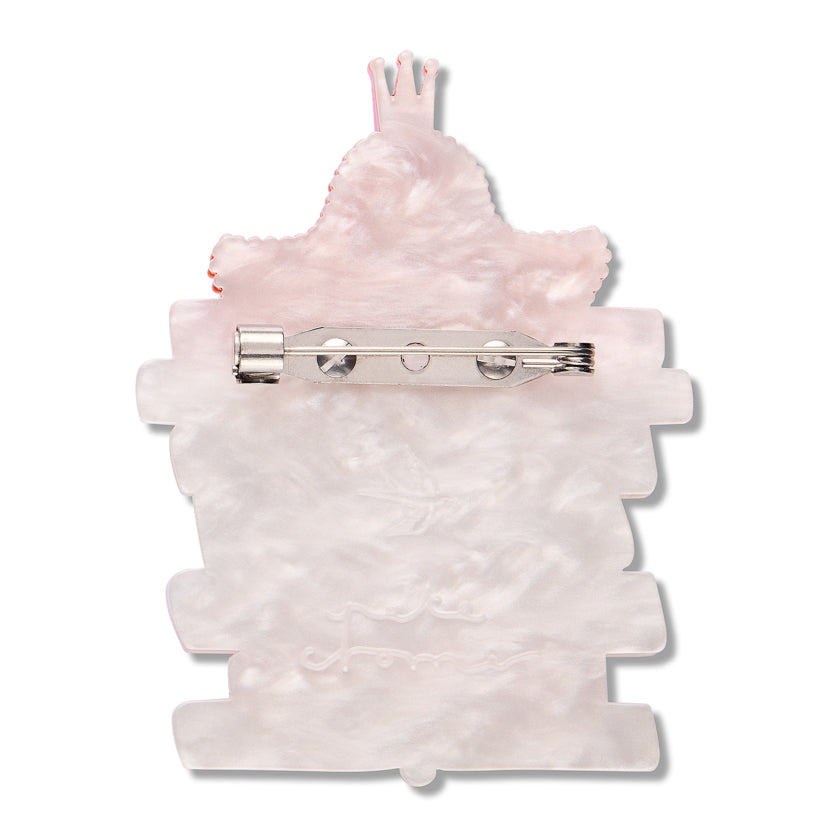 Back of Delicate Sensibilities  brooch Pink textured resin with stainless steel  pin clasp   with 

Pete Cromer signature  and Estwilder logo embedded into back on a white background