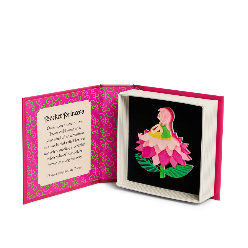 Open book with a  minute girl sitting on a flower  illustration on a black background, pink box cover with text, and green 