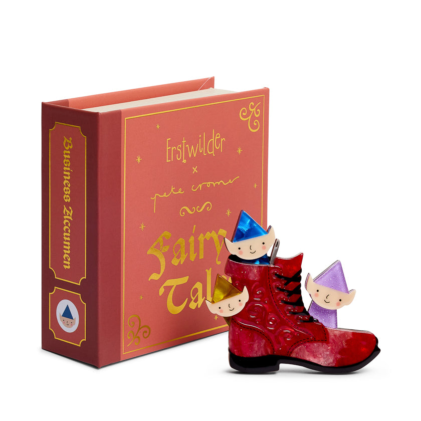 Red book titled 'Fairy Tale' boot  with small elf  fairy-like figures on a white background