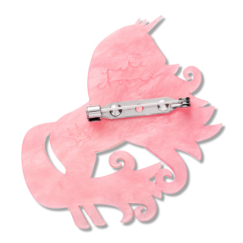 back of magical ally brooch with erstwilder logo and pete cromer signature imprint a white background