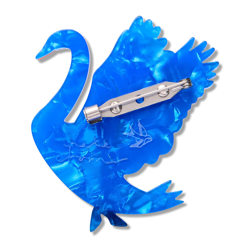 maiden curse brooch back  a Blue swan-shaped with a silver clip and clasp with Erstwilder logo and Pete Cromer signature embedded in the back  on a white background