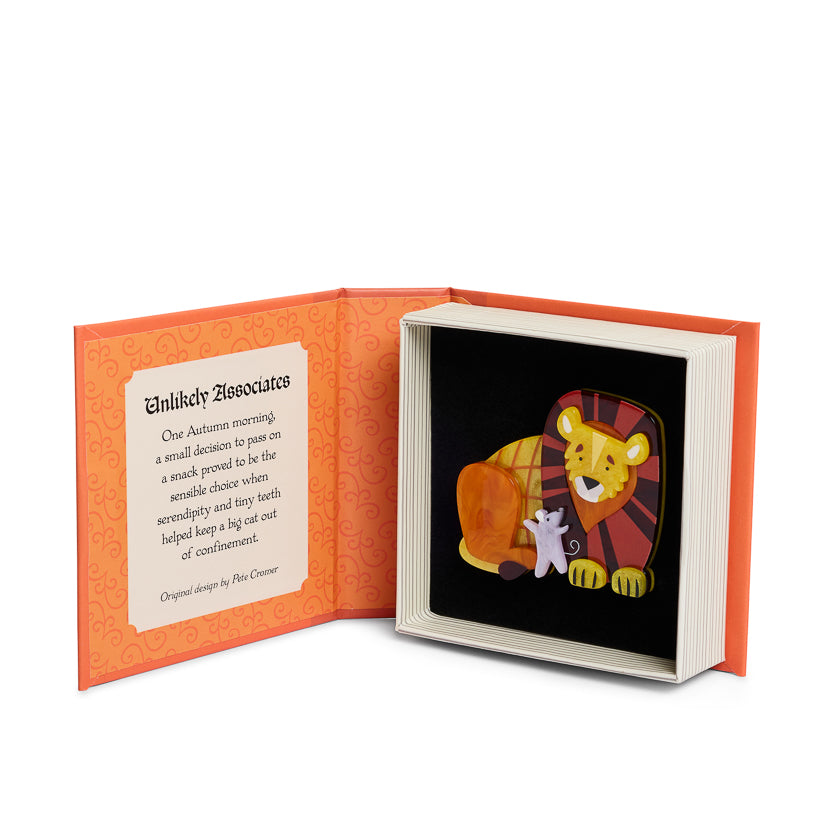 Open book with illustration of a lion and mouse on a black background