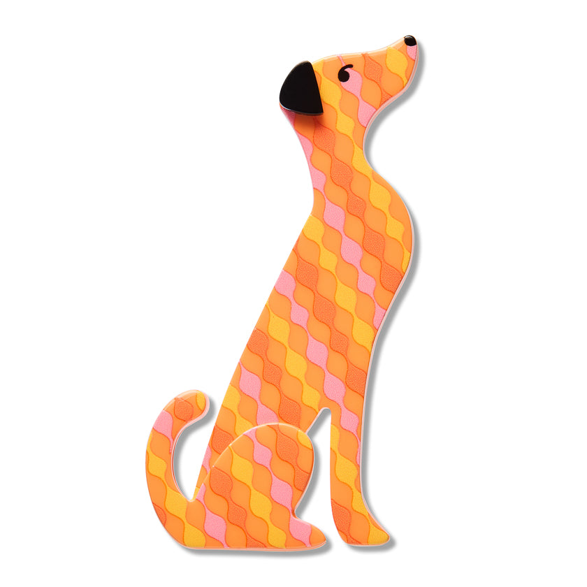 A stylized dog-shaped decorative item or sticker featuring a geometric diamond pattern in orange, yellow, and pink, with a black nose and eyes, shown on a plain white background.