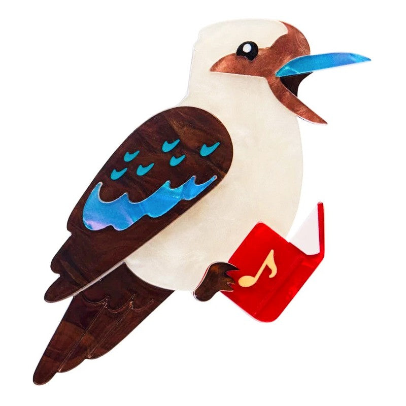 Erstwilder Kookaburra Brooch holding a red Christmas Carol song book on white background 