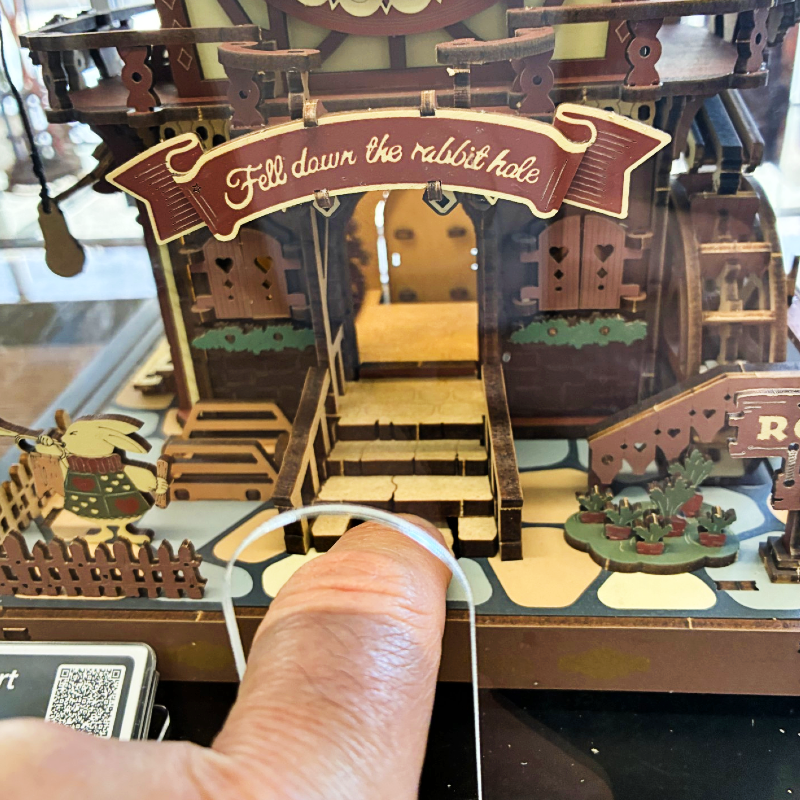 ROKR Wooden cuckoo clock pressing secret button on steps detailed design on a white background