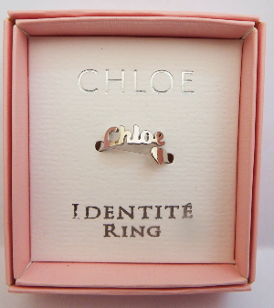 Chloe denture ring in a pink box with 'Chloe' branding.
