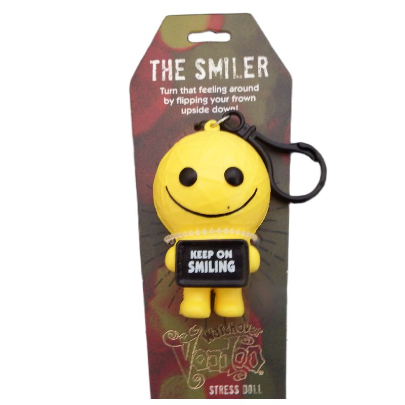 Yellow smiley face keychain with a tag on a branded packaging background