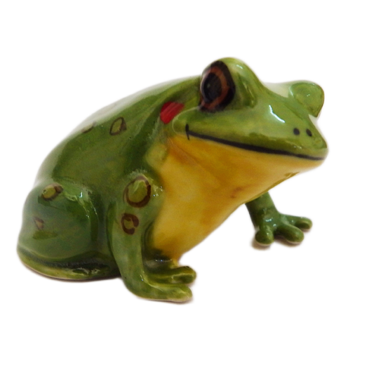 Green ceramic frog figurine with red eyes on a white background
