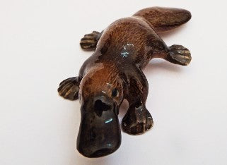 Stylized brown  platypus  animal figure on a white backgrounds 