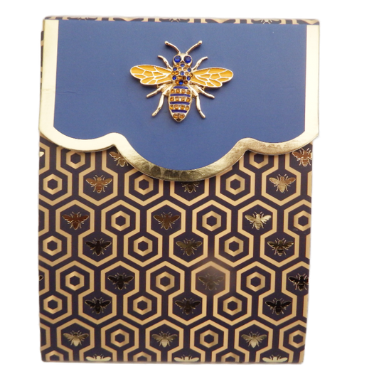 Notebook with bee design on blue cover and gold patterned cover