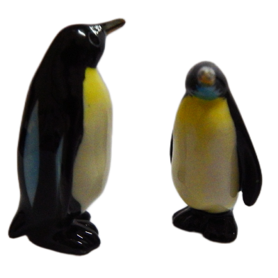 Two penguin figurines on a white background